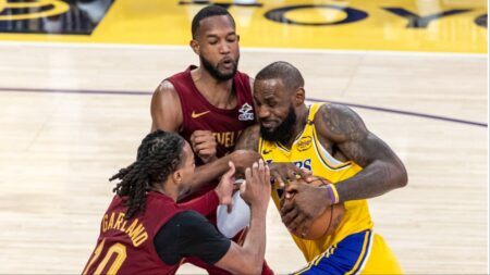 LeBron James drives to the hoop vs Evan Mobley and Darius Garland of the Cleveland Cavaliers