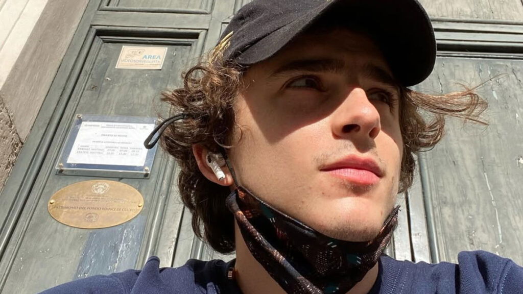 Photo of Timothee Chalamet wearing a baseball hat.