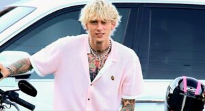 Machine Gun Kelly poses on his motorcycle