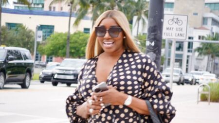 NeNe Leakes smiling in the middle of the street with a polka dot outfit.