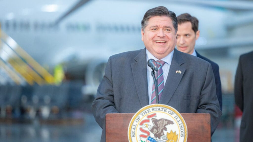 Illinois Governor JB Prizker delivering a speech at a podium