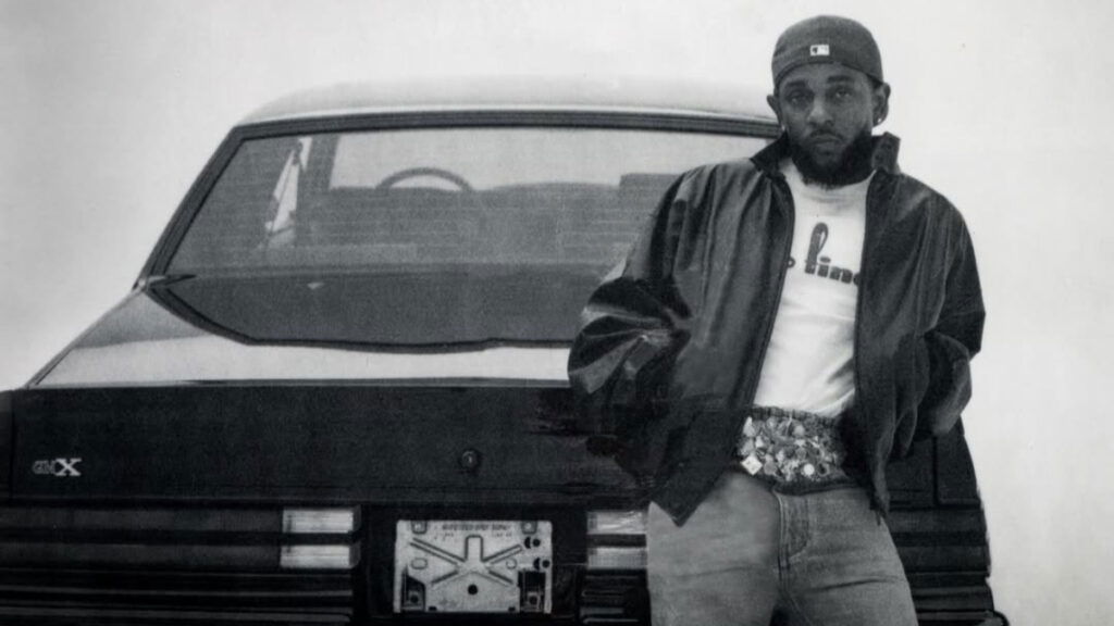 Kendrick Lamar leans against a GNX in a black and white shot