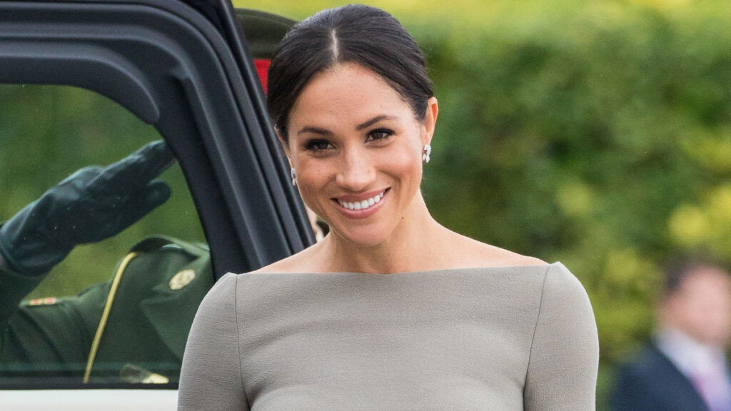 Meghan Markle wearing a gray dress.