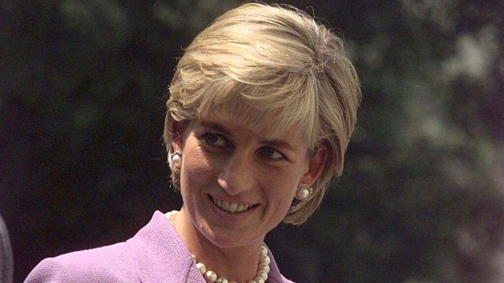 Photo of the late Princess of Wales in a purple suit.