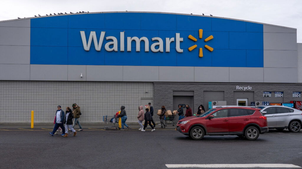 People exit the Walmart store on December 24, 2020 in Valley Stream, NY.