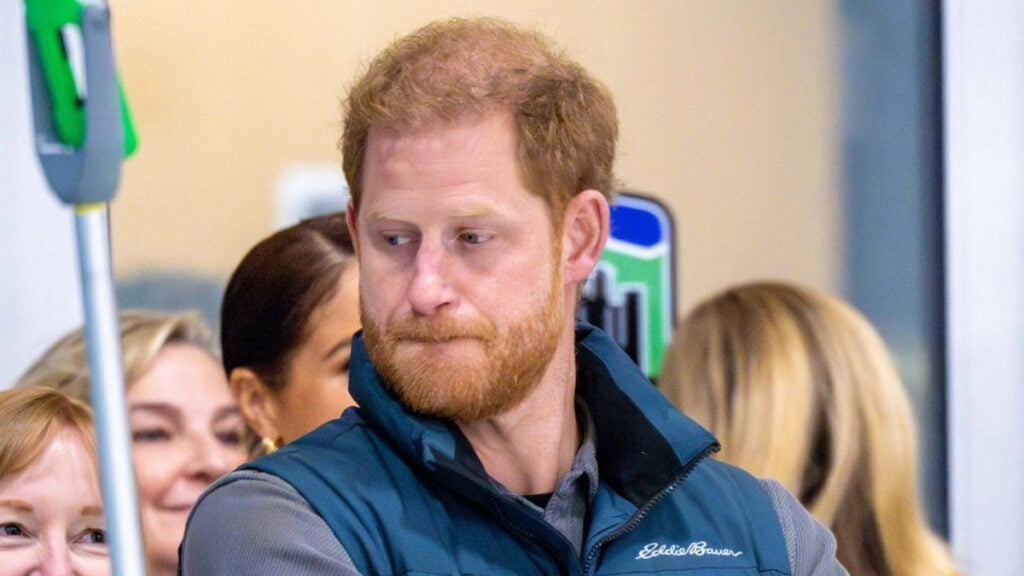 Prince Harry stands solo at an event.