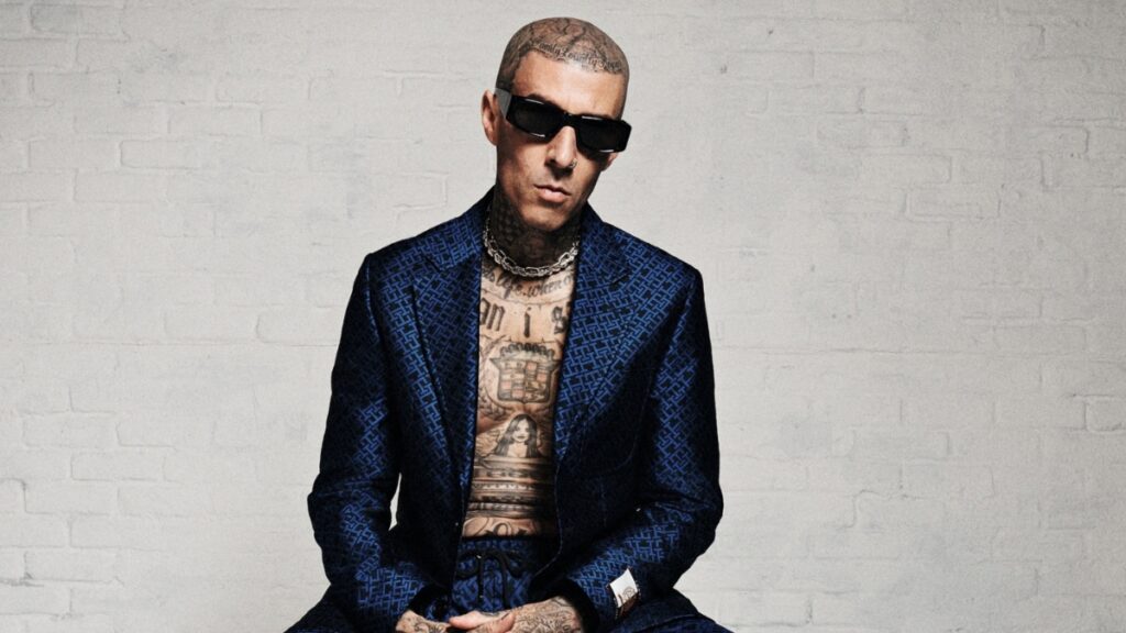 Travis Barker poses in sunglasses