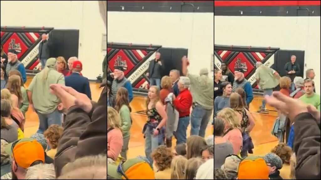 Someone snatches a red ballcap off a man's head at a Bernie Sanders town hall event in Altoona