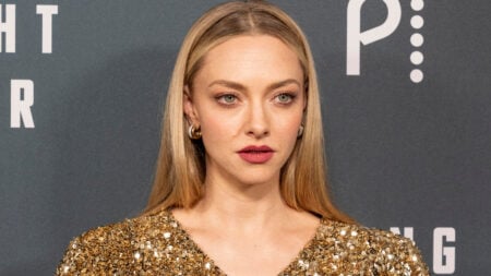 Actress Amanda Seyfried in a red dress on the red carpet.