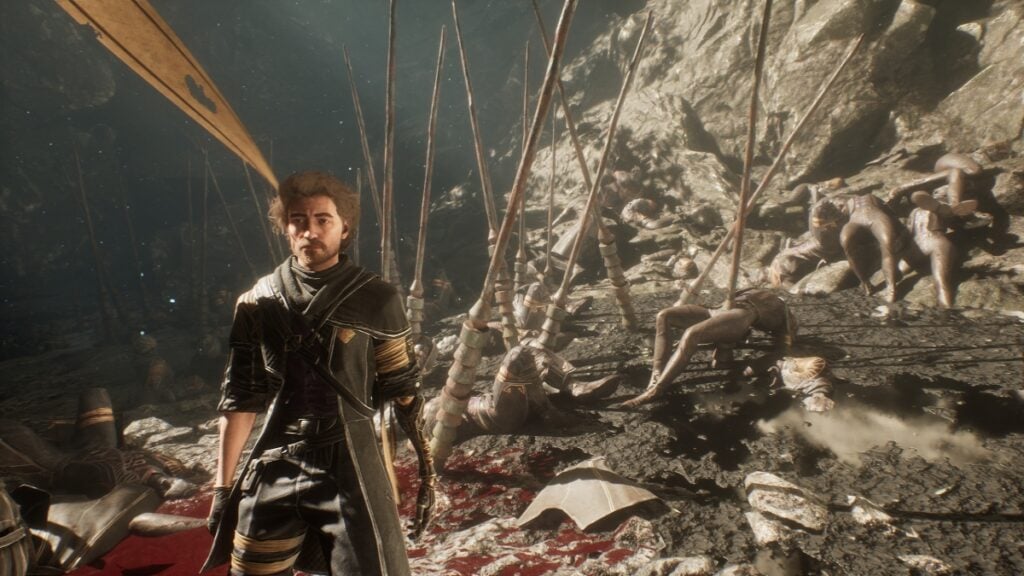 The protagonist stands on a battlefield, bodies impaled on spikes behind him in Clair Obscur: Expedition 33