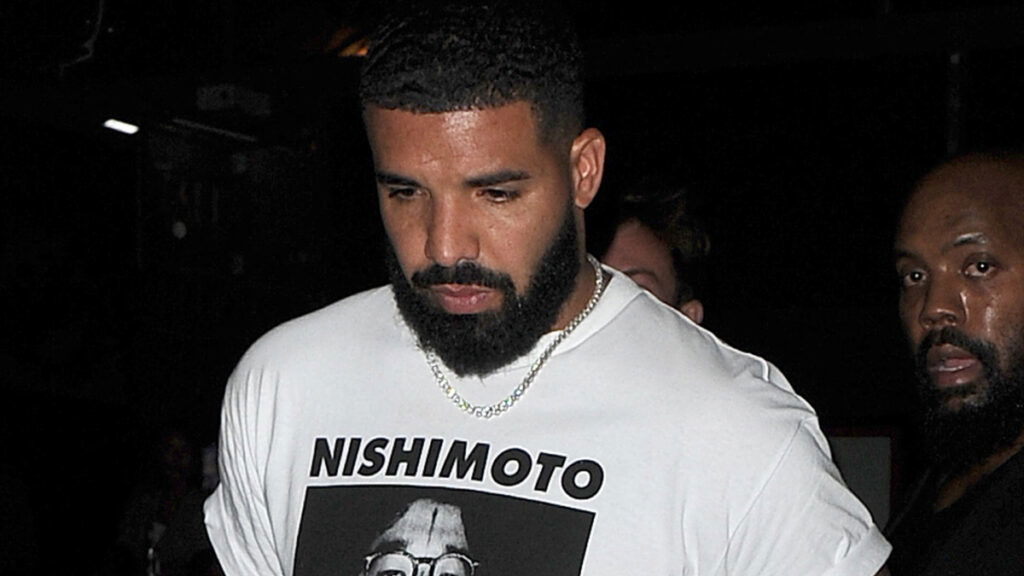 Drake wearing a white top.