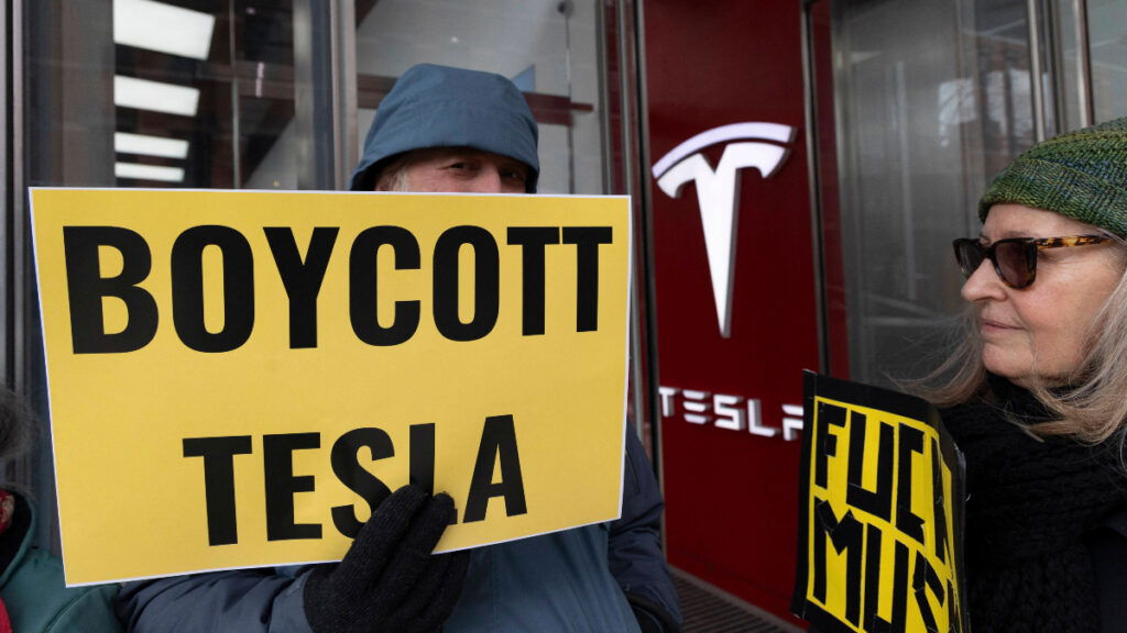 Protesters rally against Elon Musk's tech company, Tesla.