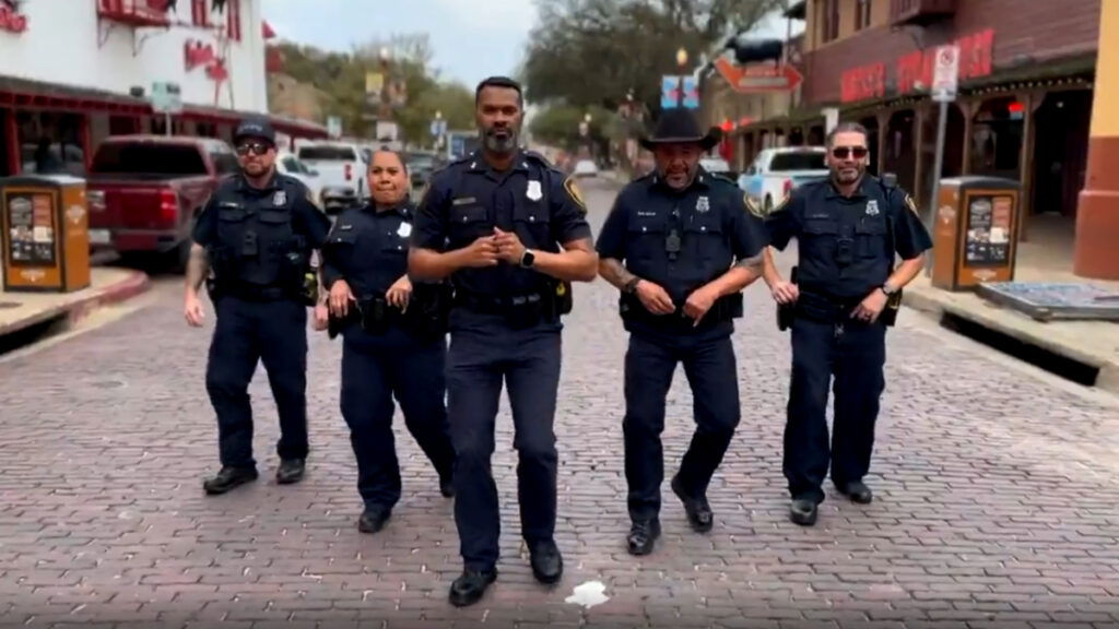 Officers in a rap recruiting video for Fort Worth PD dance together in the street