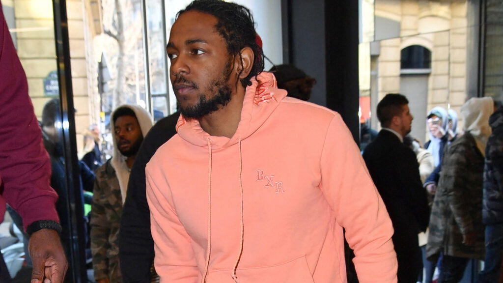 Rapper Kendrick Lamar in pink tracksuit presents the DAMN collection at the new concept store NOUS in Paris.