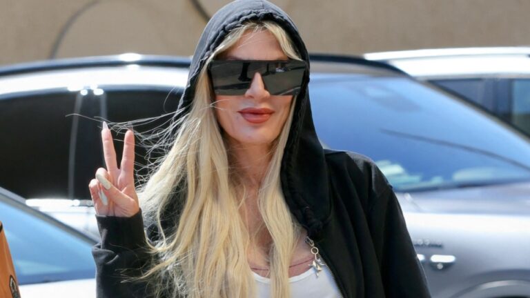 Tori Selling’s Decision To Sit On the Lap of Her Former Costar Has Infuriated Fans: ‘You’re Not a Child’ Tori Spelling poses for the cameras with a peace sign outside the DWTS studio.