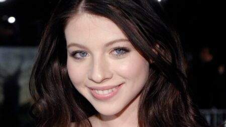 Michelle Trachtenberg smiles at an event.