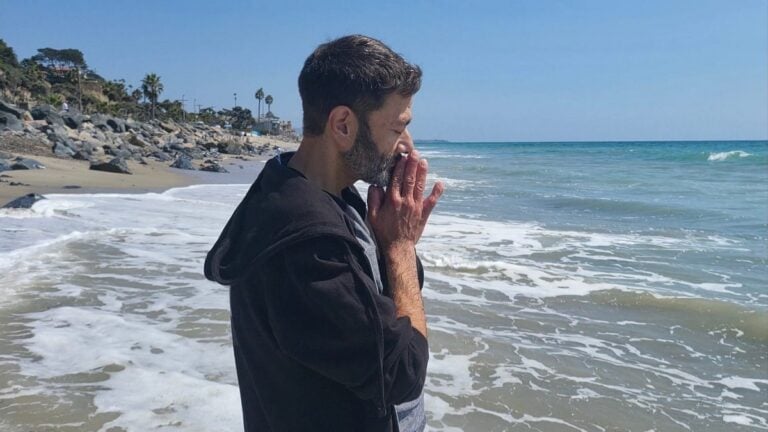 Actor Shaun Weiss on a beach, standing in the ocean