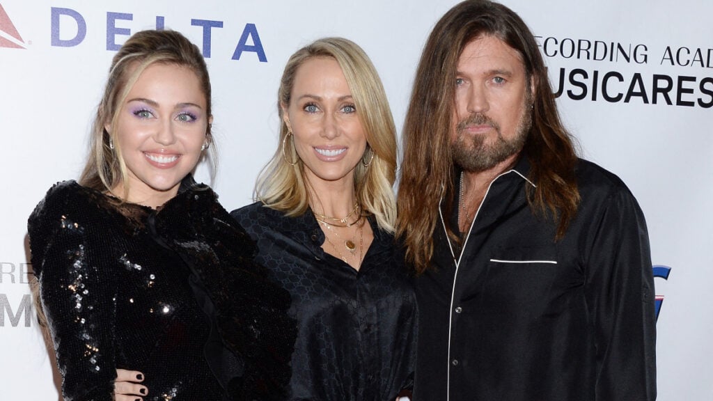 Miley Cyrus with her parents Billy Ray Cyrus and Tish Cyrus on the red carpet.