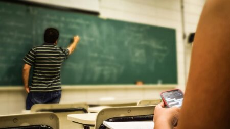 A picture of a teacher in a classroom in relation to the Utah teacher.