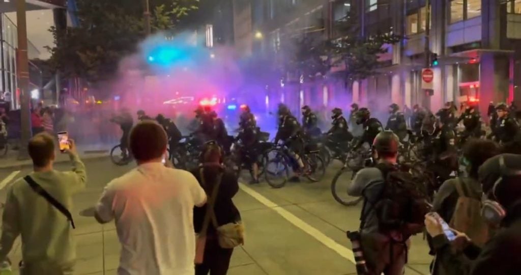 Seattle police charge protestors in bicycles