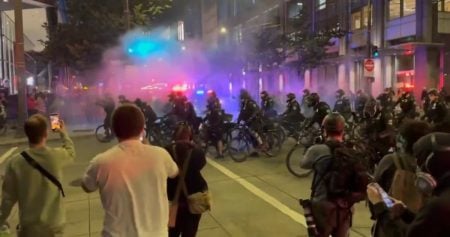 Seattle police charge protestors in bicycles